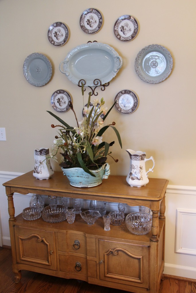 Plate display over antique dining room sideboard